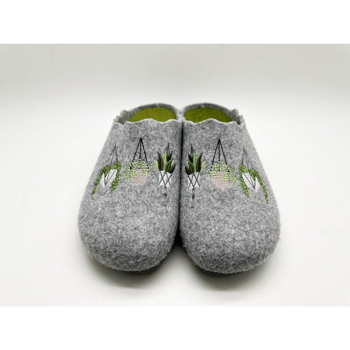 Pair of gray slippers with embroidered designs on a white background