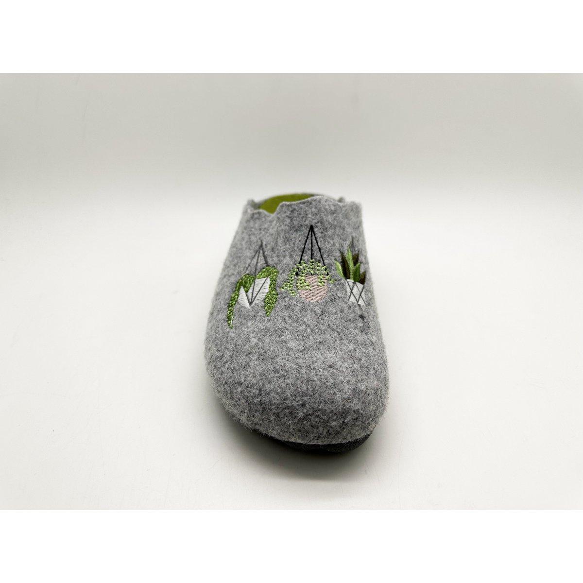 Gray felted slippers with green designs on a white background