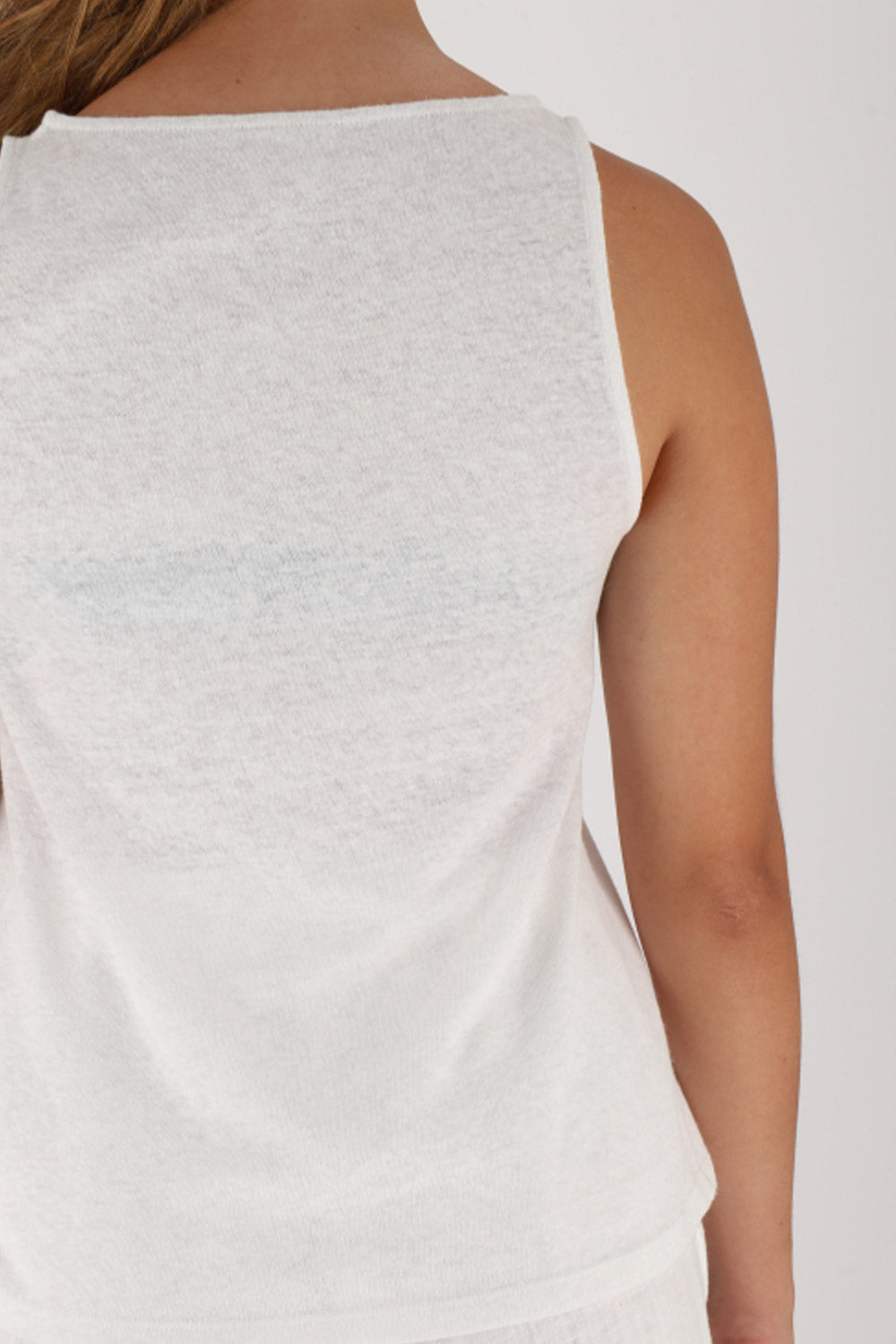 Back view of linen tank top featuring a rounded neckline and contrasting topstitching.