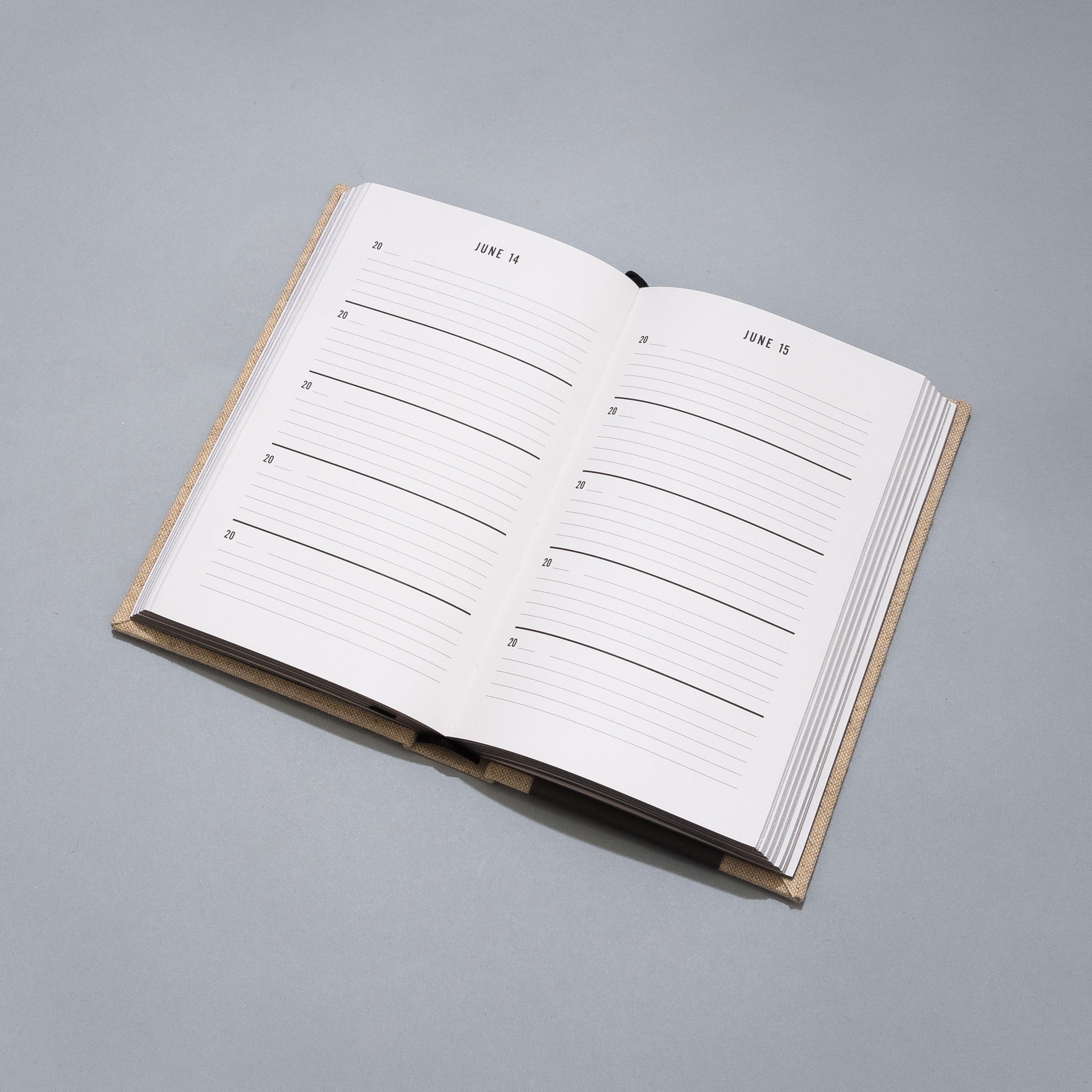Open planner with a grid layout on a gray background