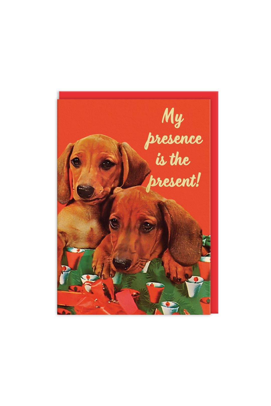 Card with two dachshunds and text 'My presence is the present!' on a red background