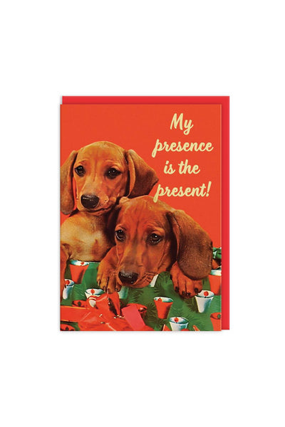 Card with two dachshunds and text 'My presence is the present!' on a red background