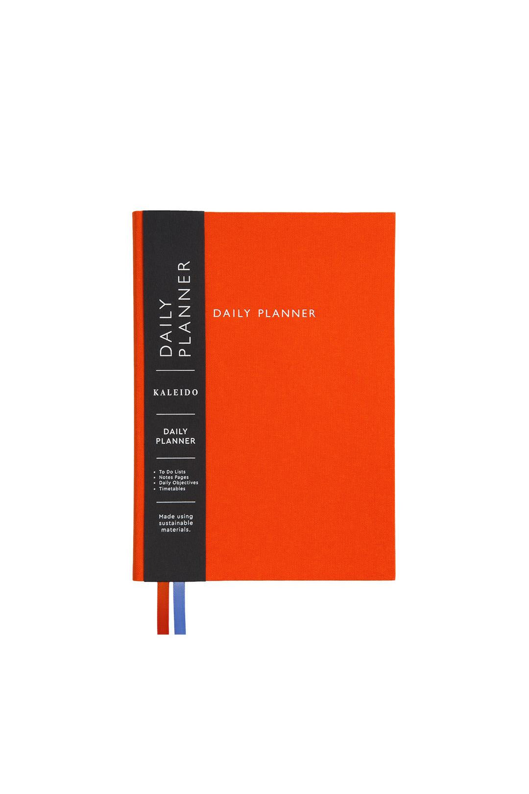 Orange daily planner with black spine on a white background