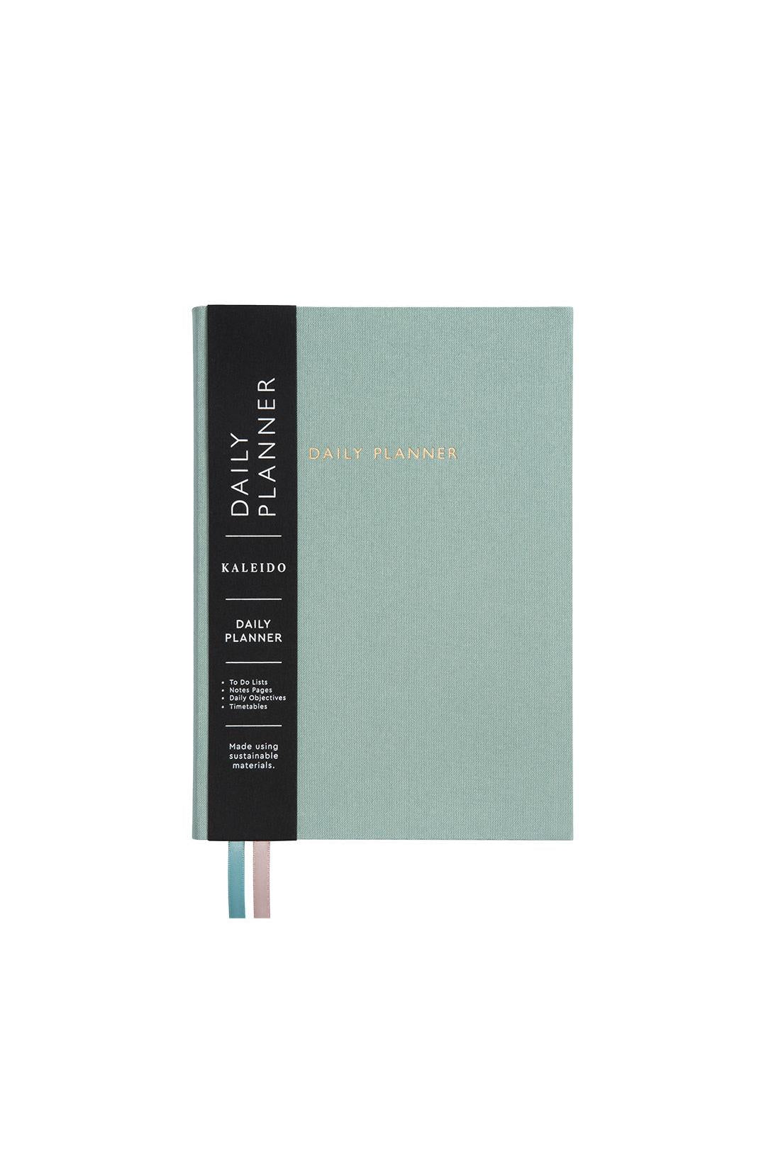 Green daily planner with black spine on a white background