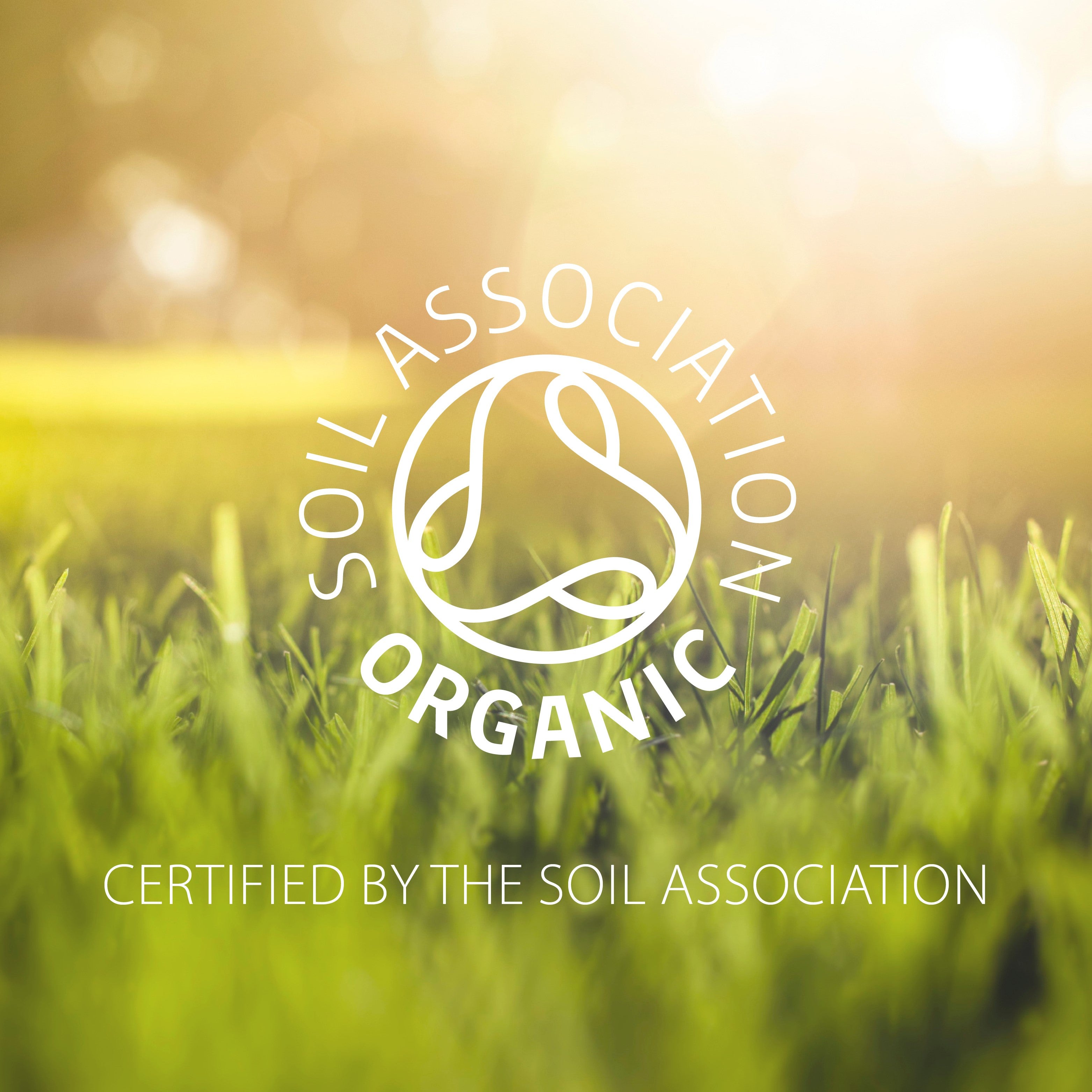 Soil Association Organic certification logo over a blurred green field background