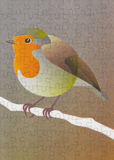 A jigsaw of a robin sitting on a branch
