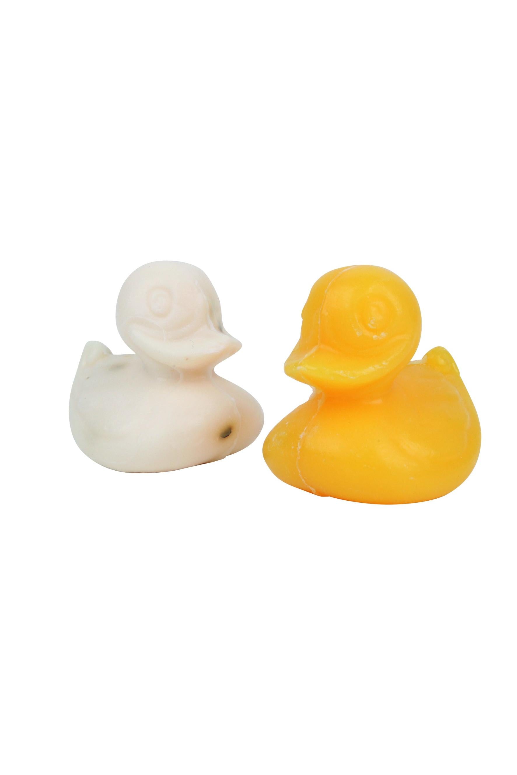Two soap ducks, one white and one yellow, on a white background