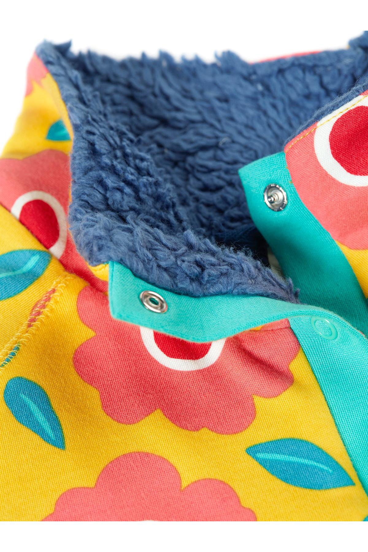 Close-up of a colorful fabric with floral patterns and blue interior lining.