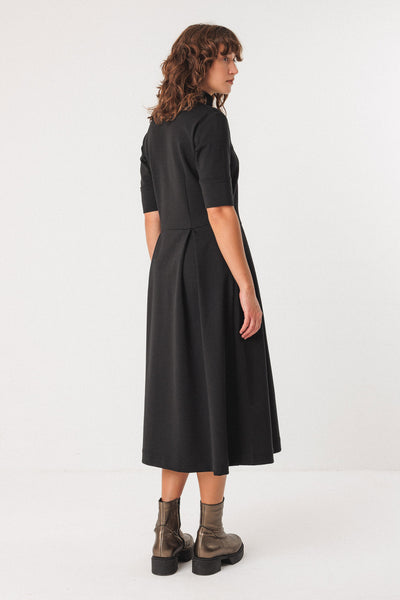 Woman wearing a black tencel dress on a white background