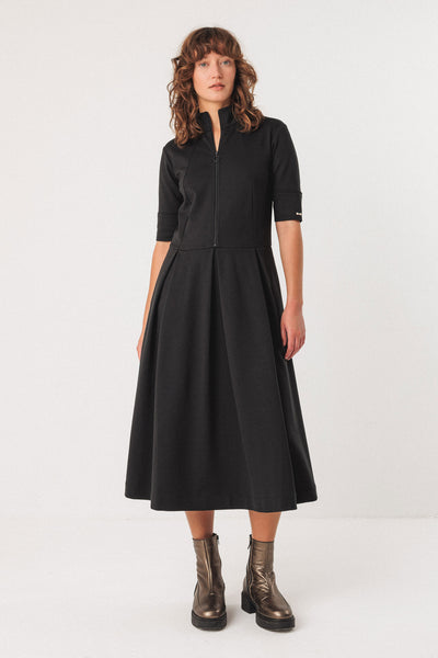 Woman wearing a black tencel dress with a white background