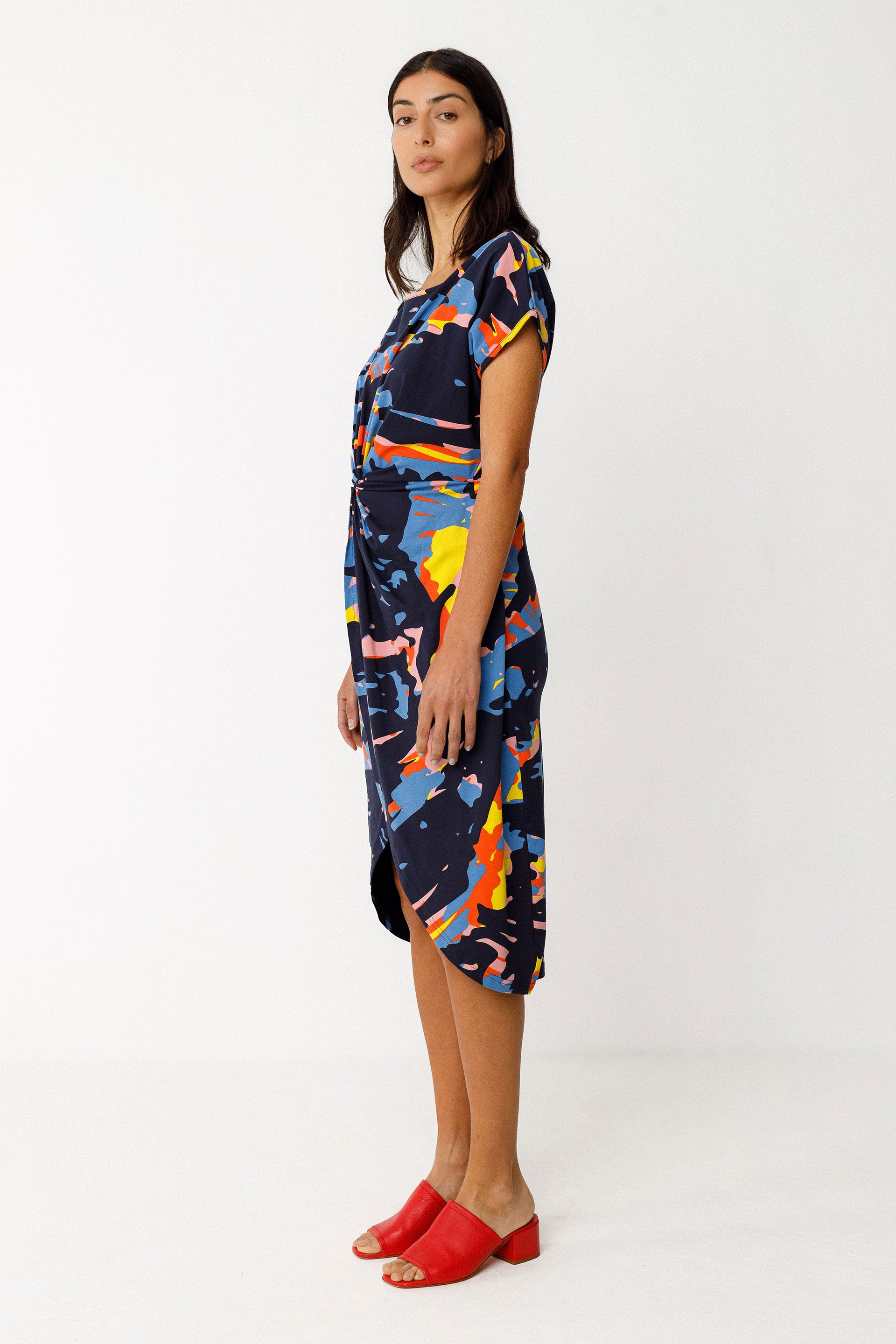 Side view of model wearing colourful knee length dress