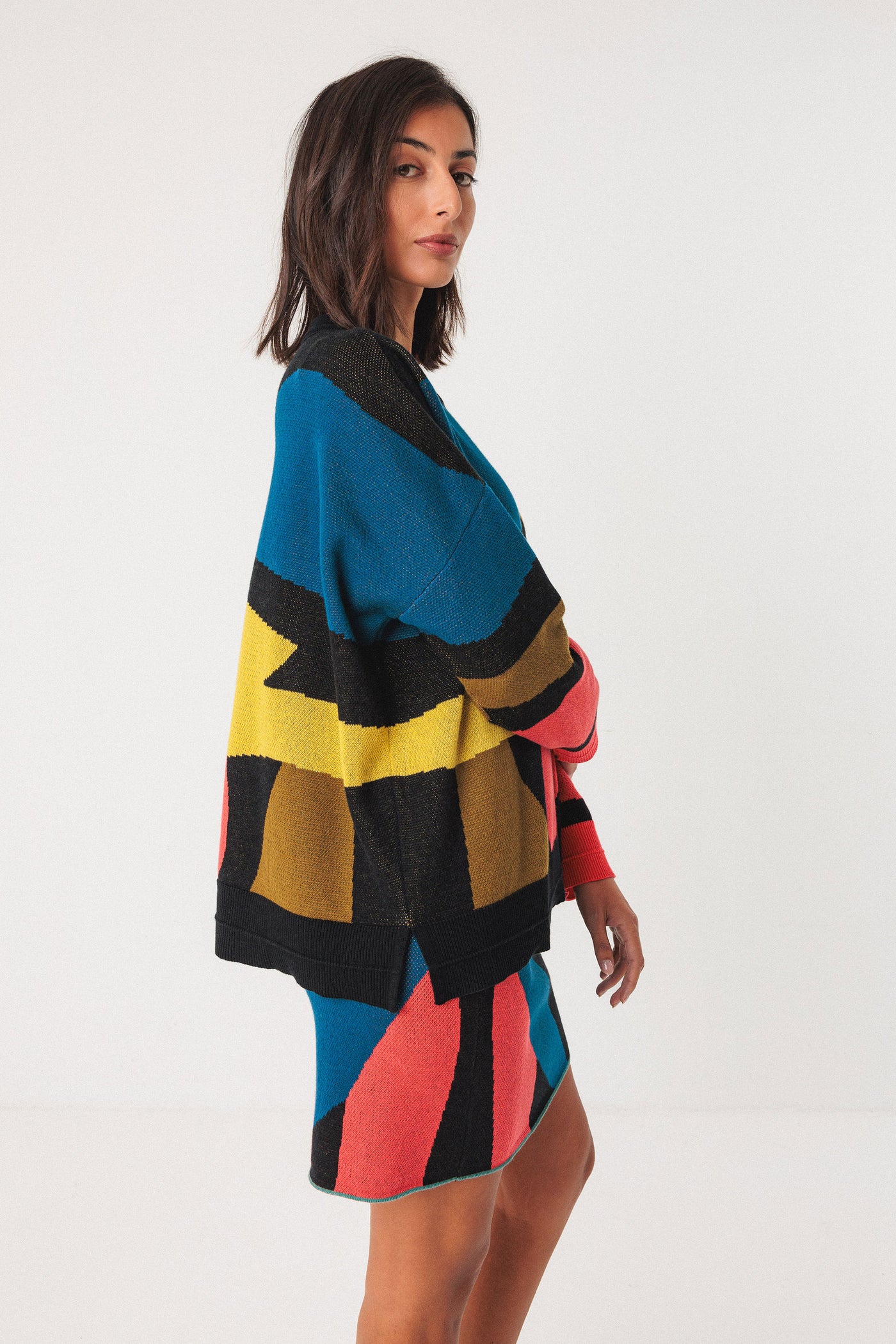 Woman wearing a colorful patterned co-ord on a white background