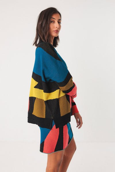 Woman wearing a colorful patterned co-ord on a white background
