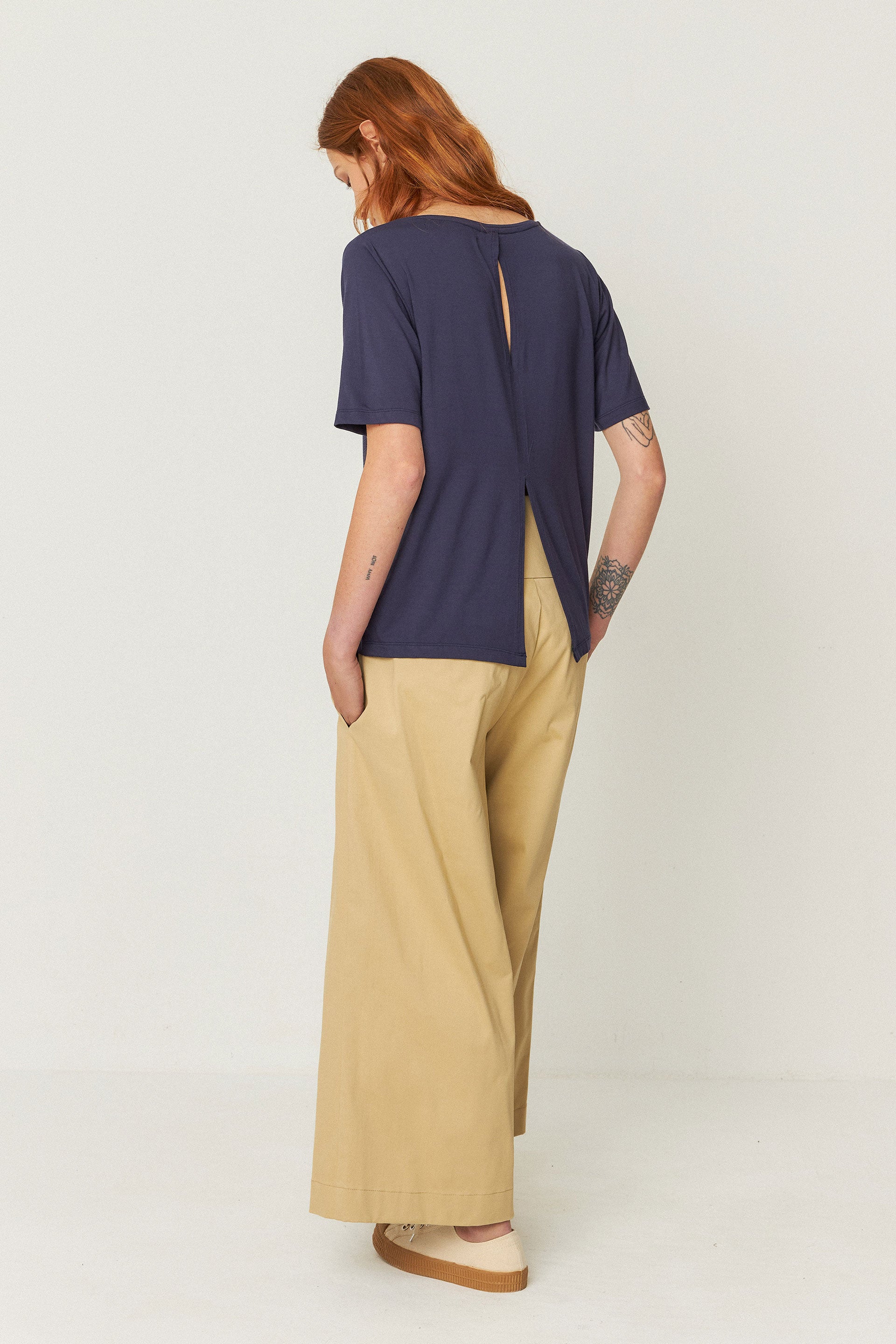 A rear view of the t-shirt, showing the split  detail at the back and how it sits on the model.