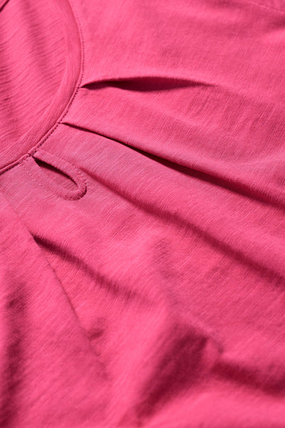 Close-up of the T-shirt’s organic cotton fabric showing a keyhole detail.