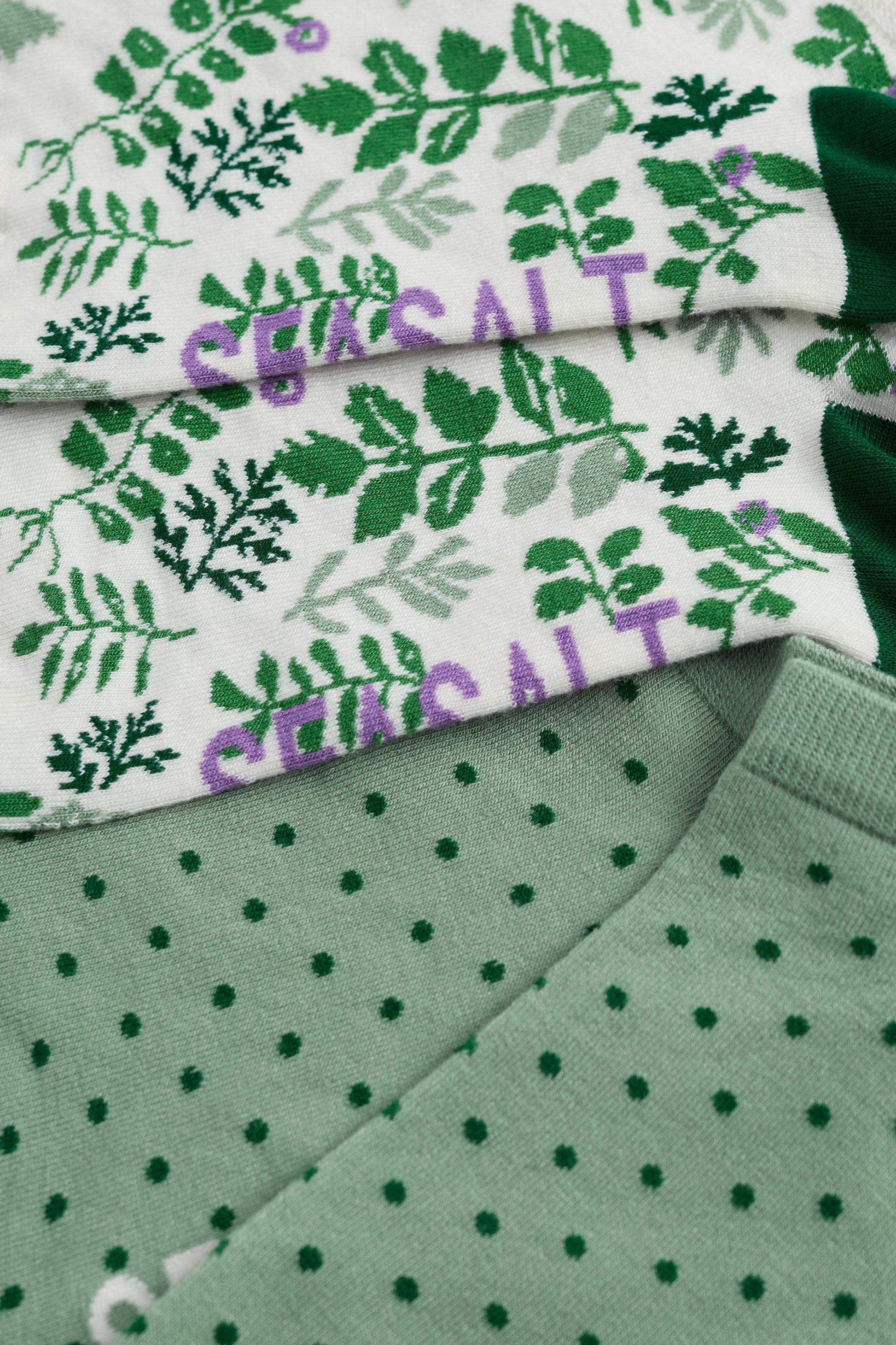 Green and white patterned fabric with visible brand name.