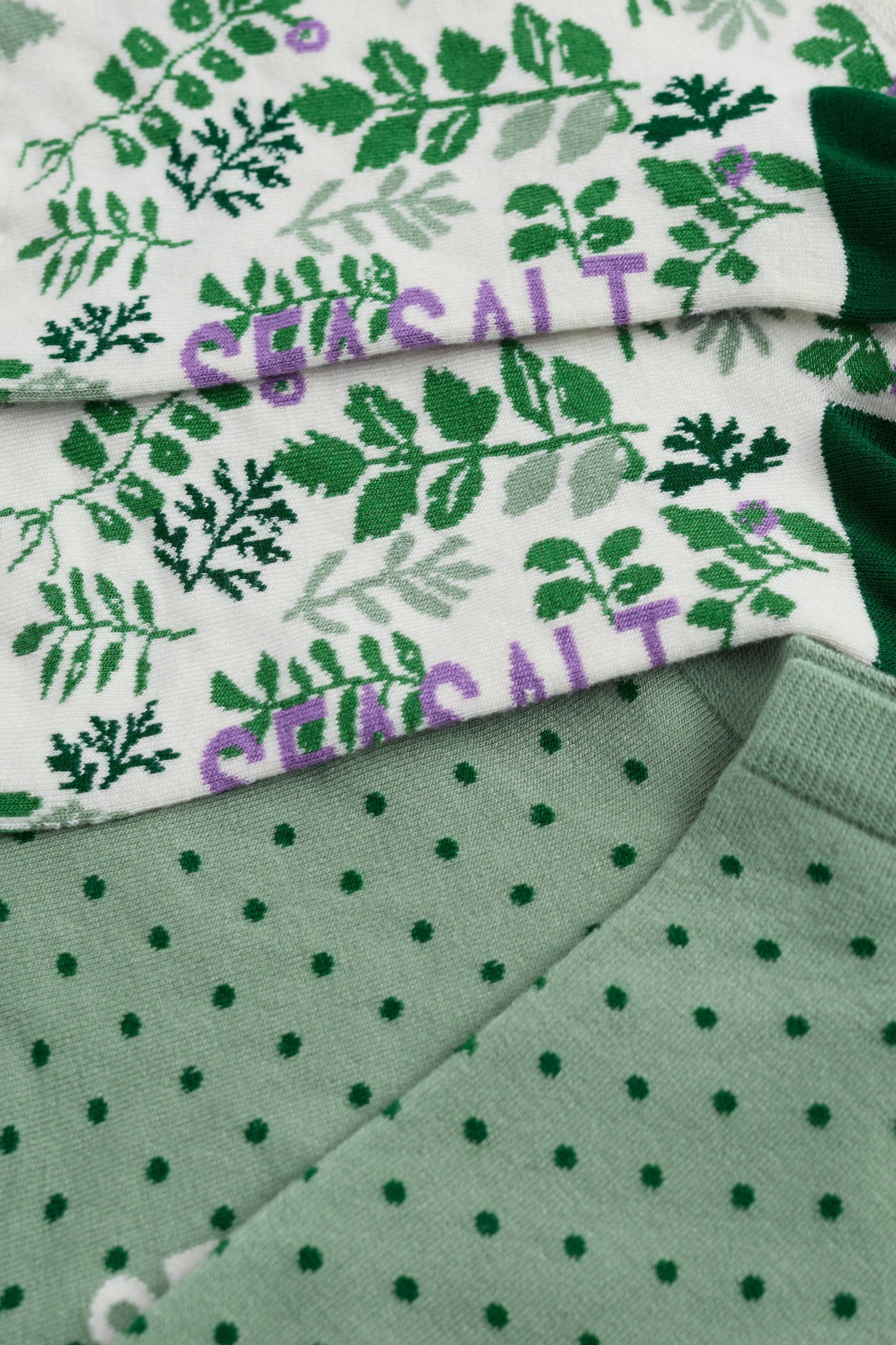 Green and white patterned fabric with visible brand name.