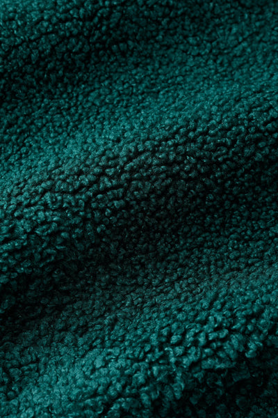 Close-up of teal textured recycled polyester fabric