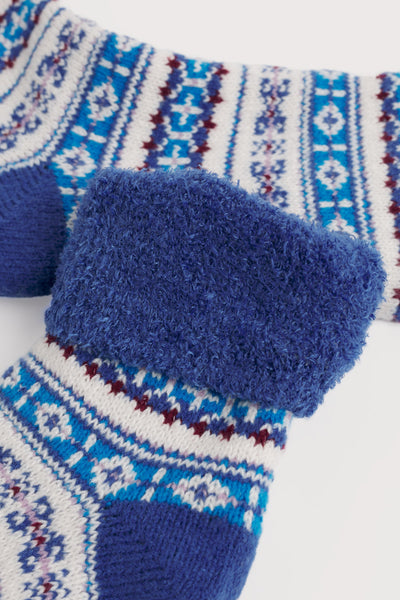 Blue patterned socks with fuzzy texture on a white background
