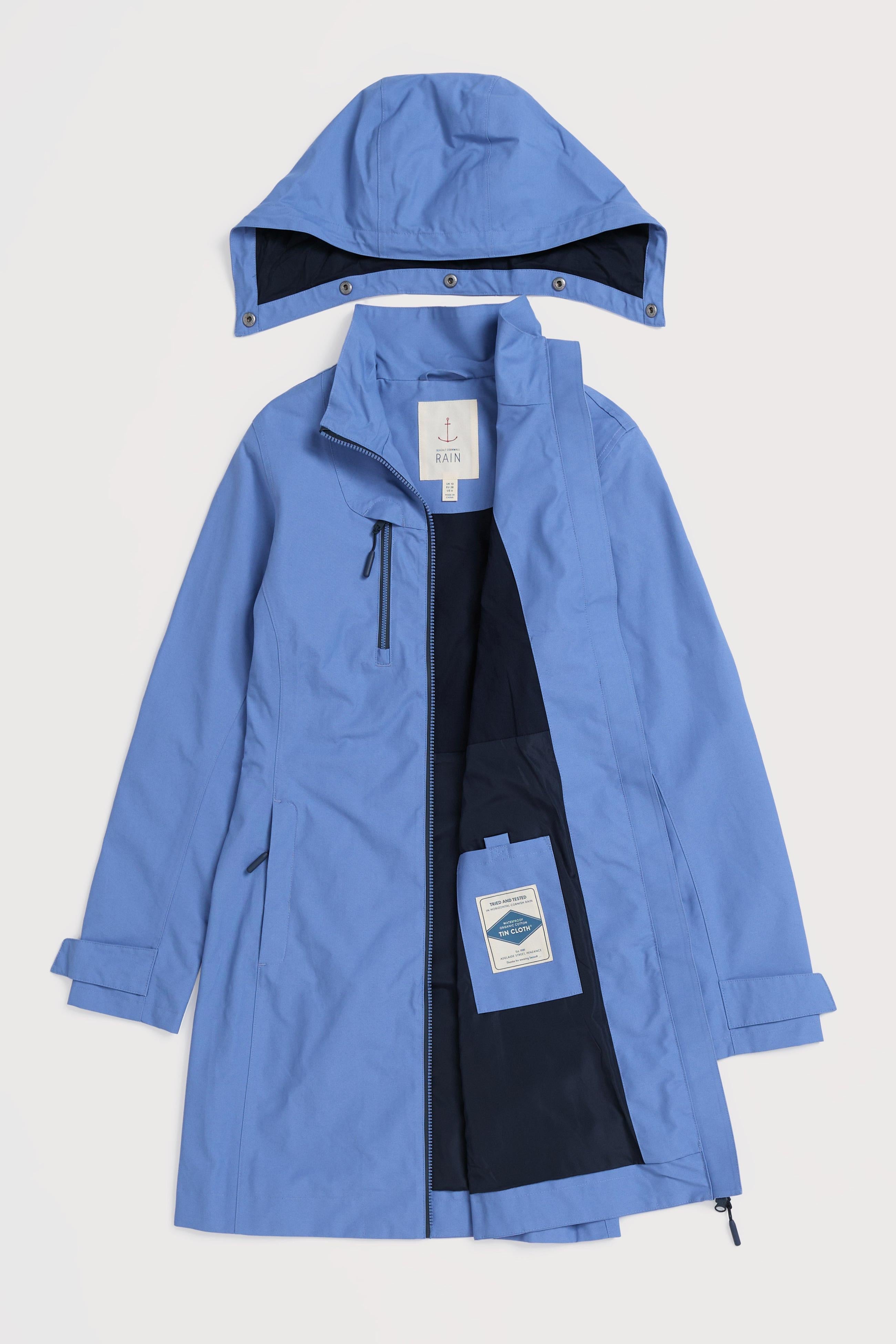 Blue raincoat with a hood on a light gray background