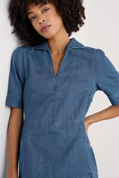 Close-up of the dress's fabric texture, illustrating the mid-wash denim's weave and the subtle stitching details around the collar and sleeves.