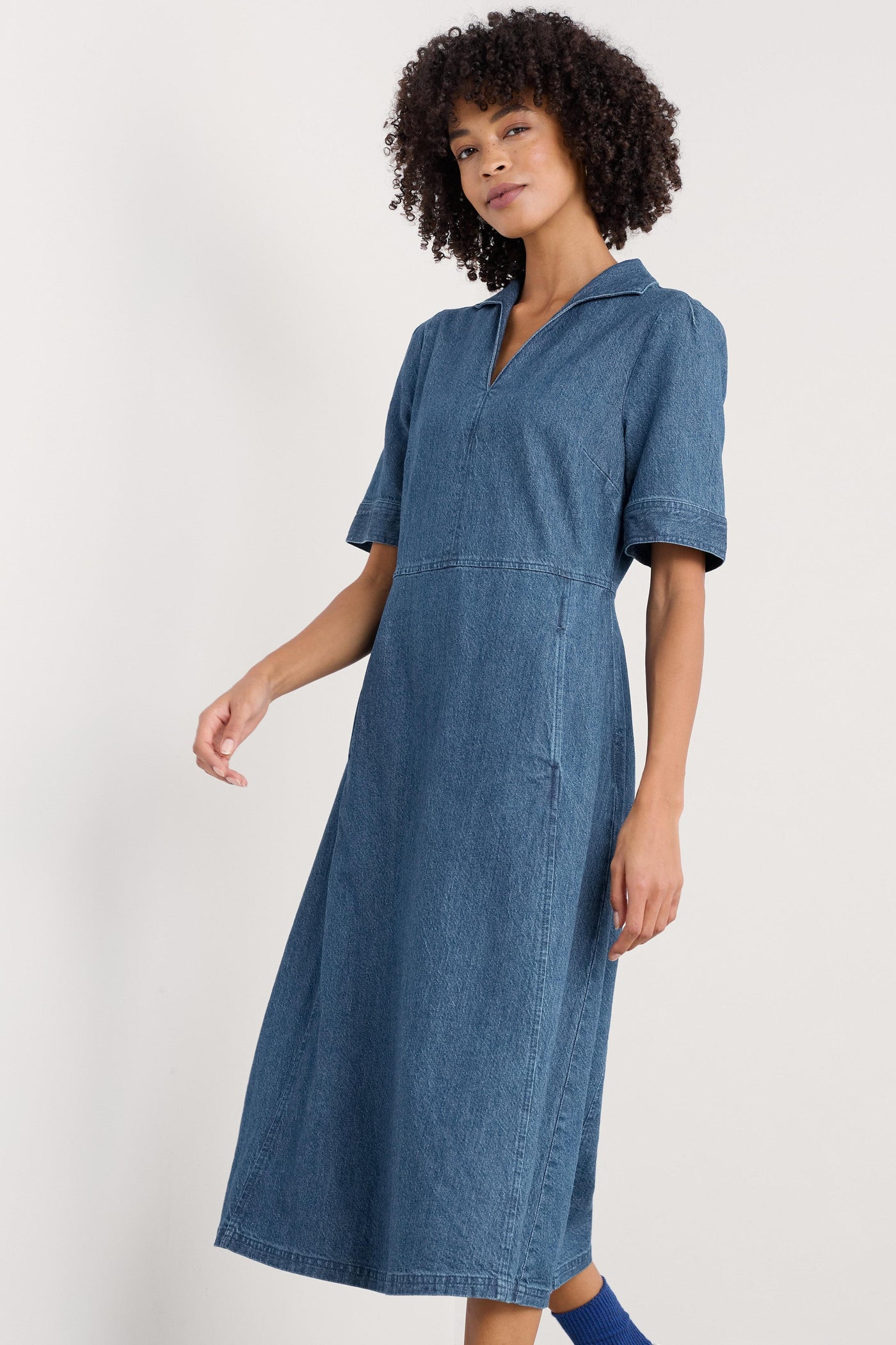Side profile of the dress showcasing the tailored and the natural drape of the organic cotton and linen-blend fabric.