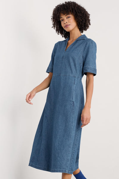 Side profile of the dress showcasing the tailored and the natural drape of the organic cotton and linen-blend fabric.