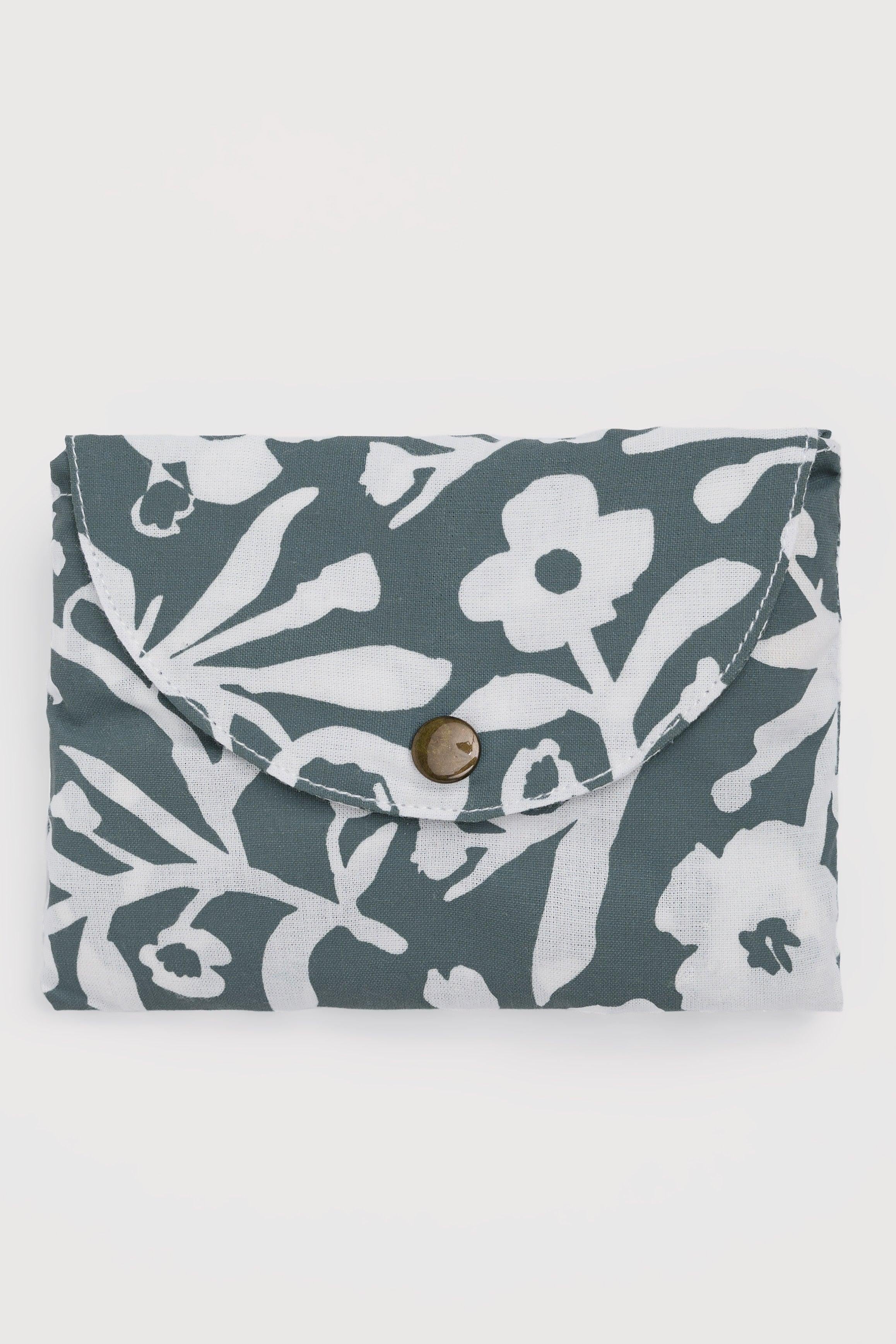 Floral organic cotton clutch bag with a button on a white background
