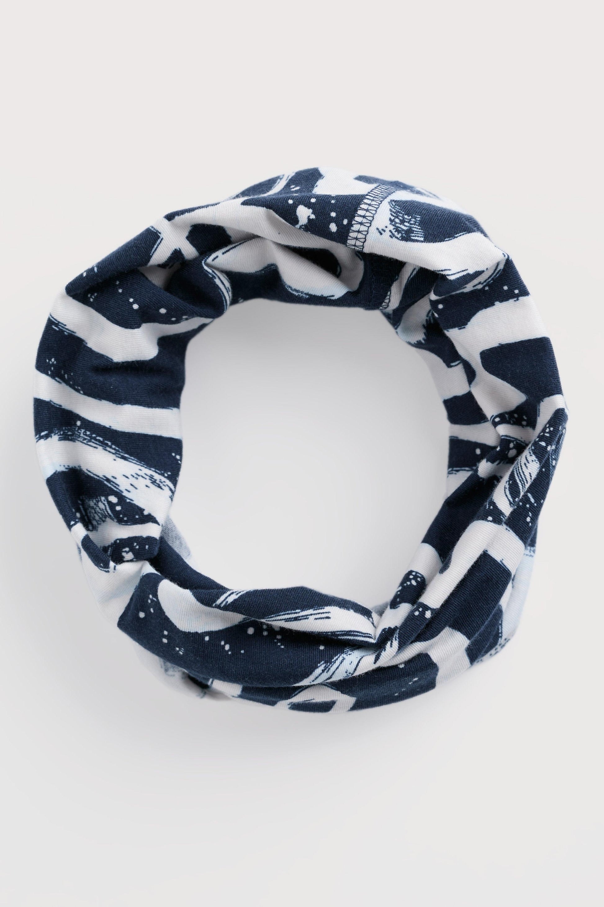Navy and white patterned headband on a light gray background