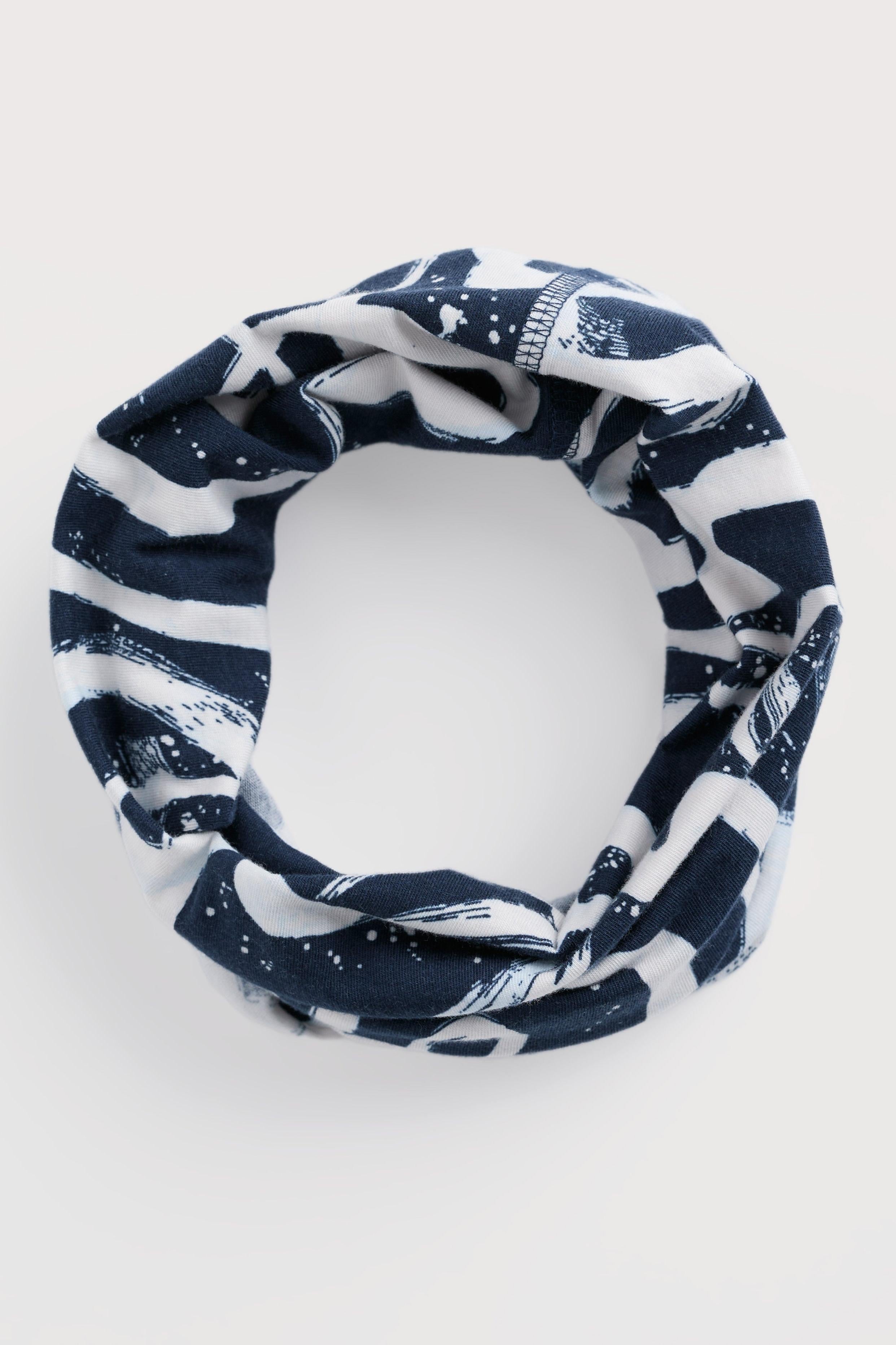 Navy and white patterned headband on a light gray background