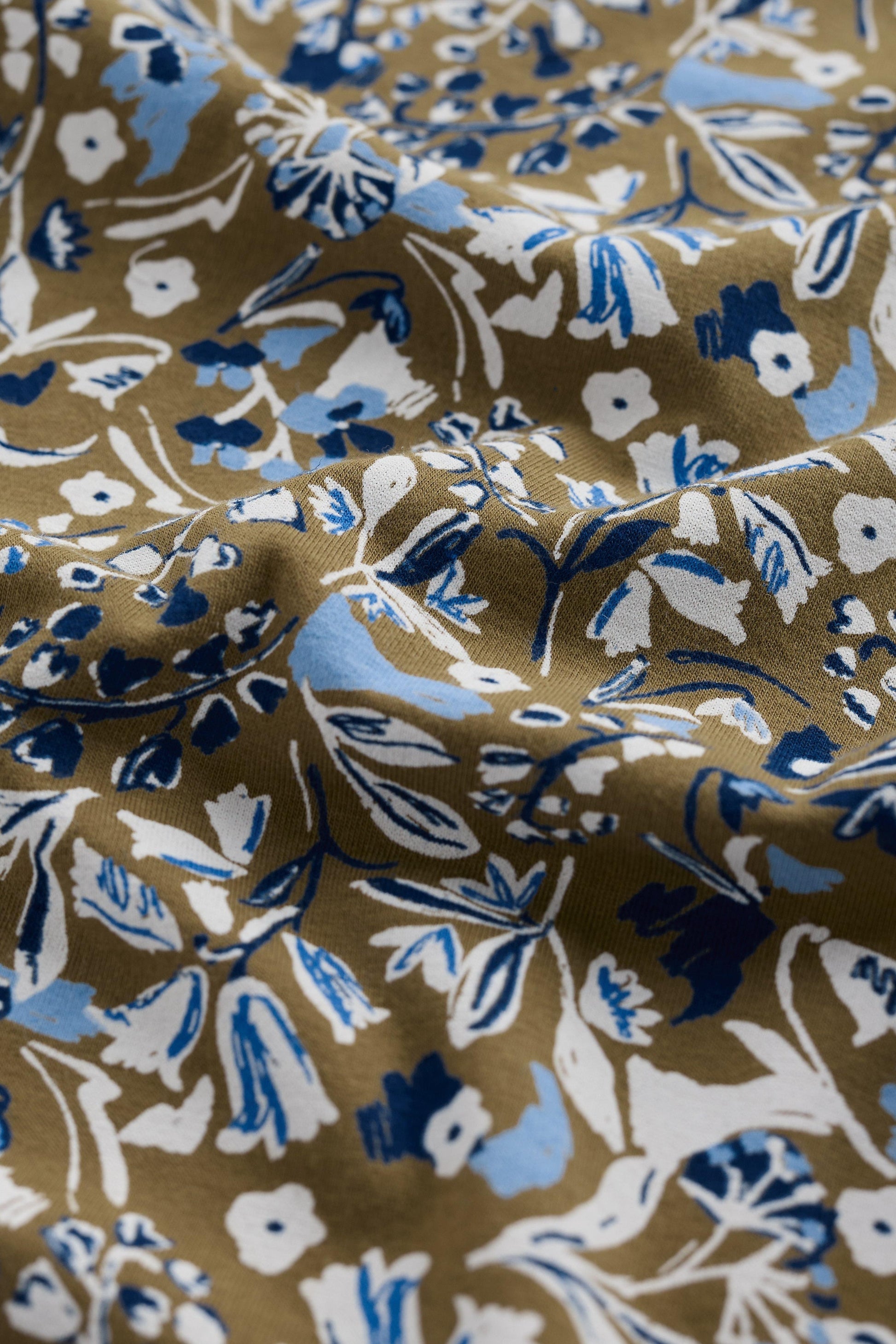 Floral patterned fabric with blue, white, and brown colors.