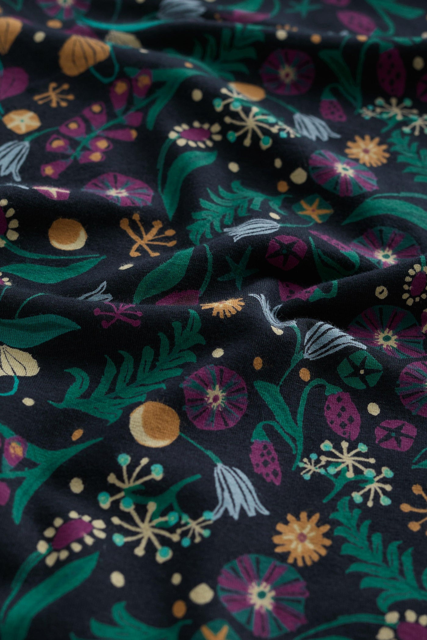 Close-up of dark fabric with colorful floral pattern