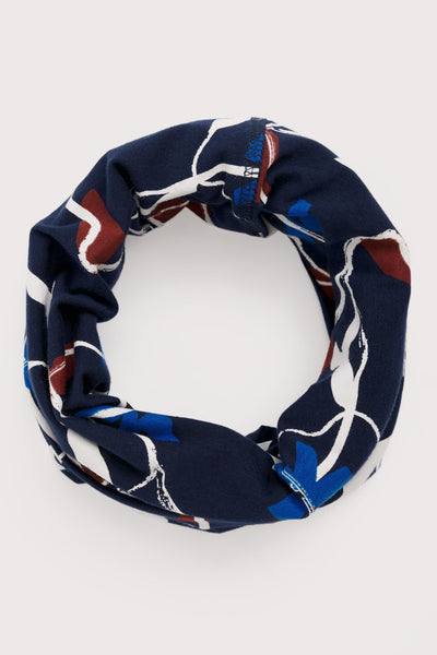 Navy blue organic cotton headband with abstract pattern on a white background