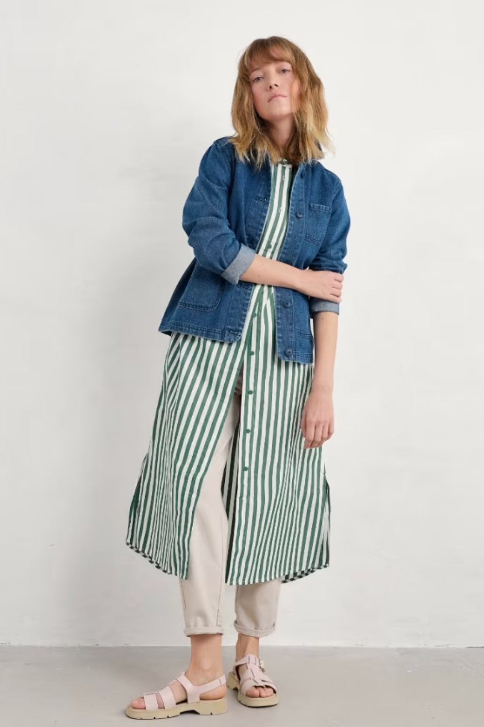 Model wearing Seasalt Harbour Movement Dress layered with a blue denim jacket and sandals.