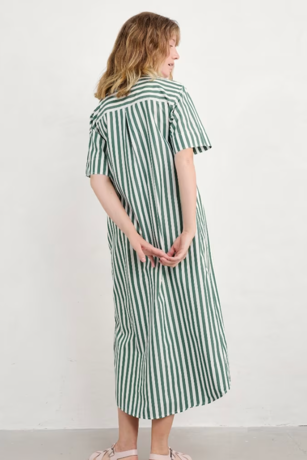 Back view of the Seasalt Harbour Movement Dress, showing vertical stripe pattern and midi length.