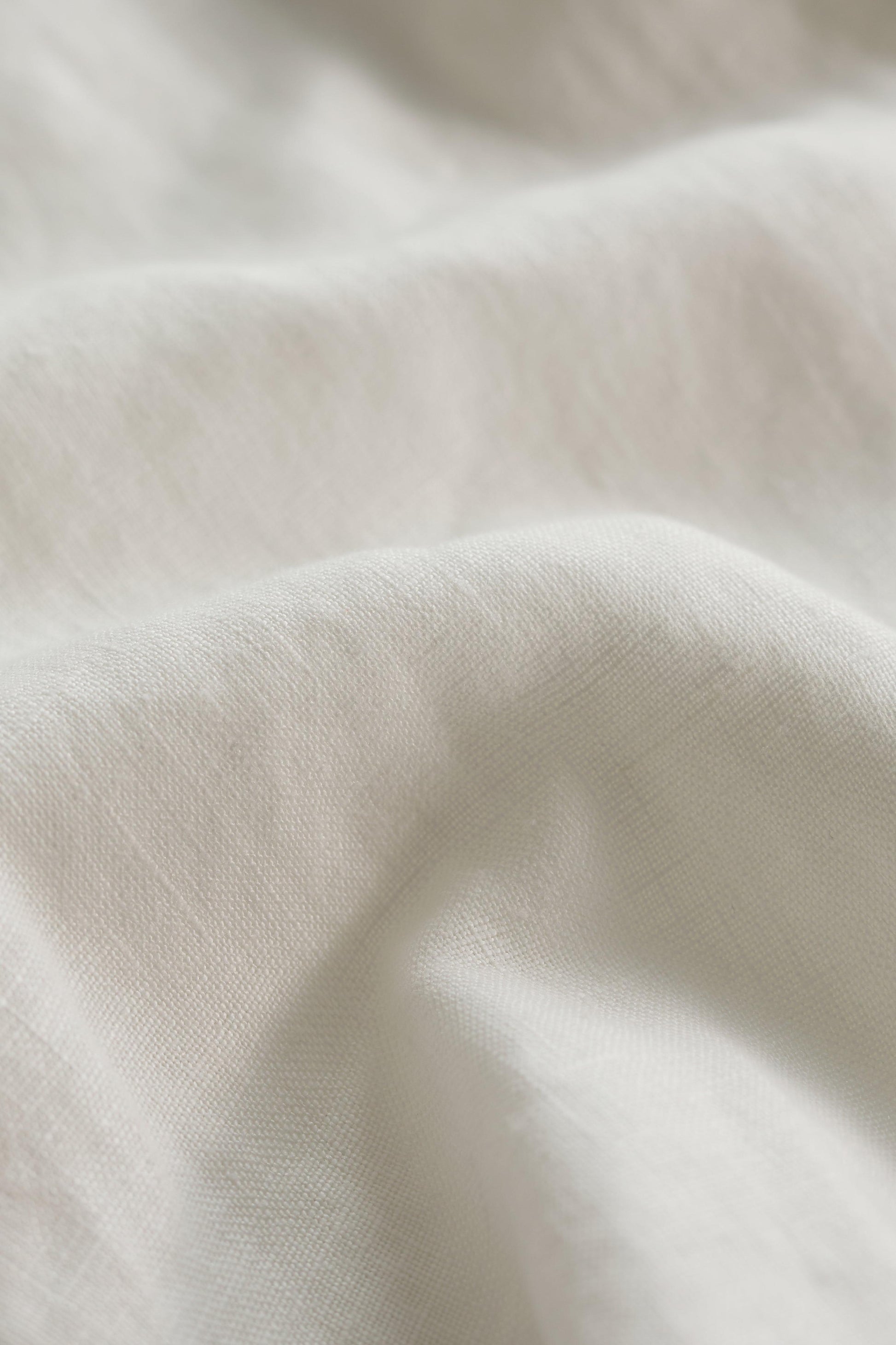 Close-up of white linen fabric with soft texture