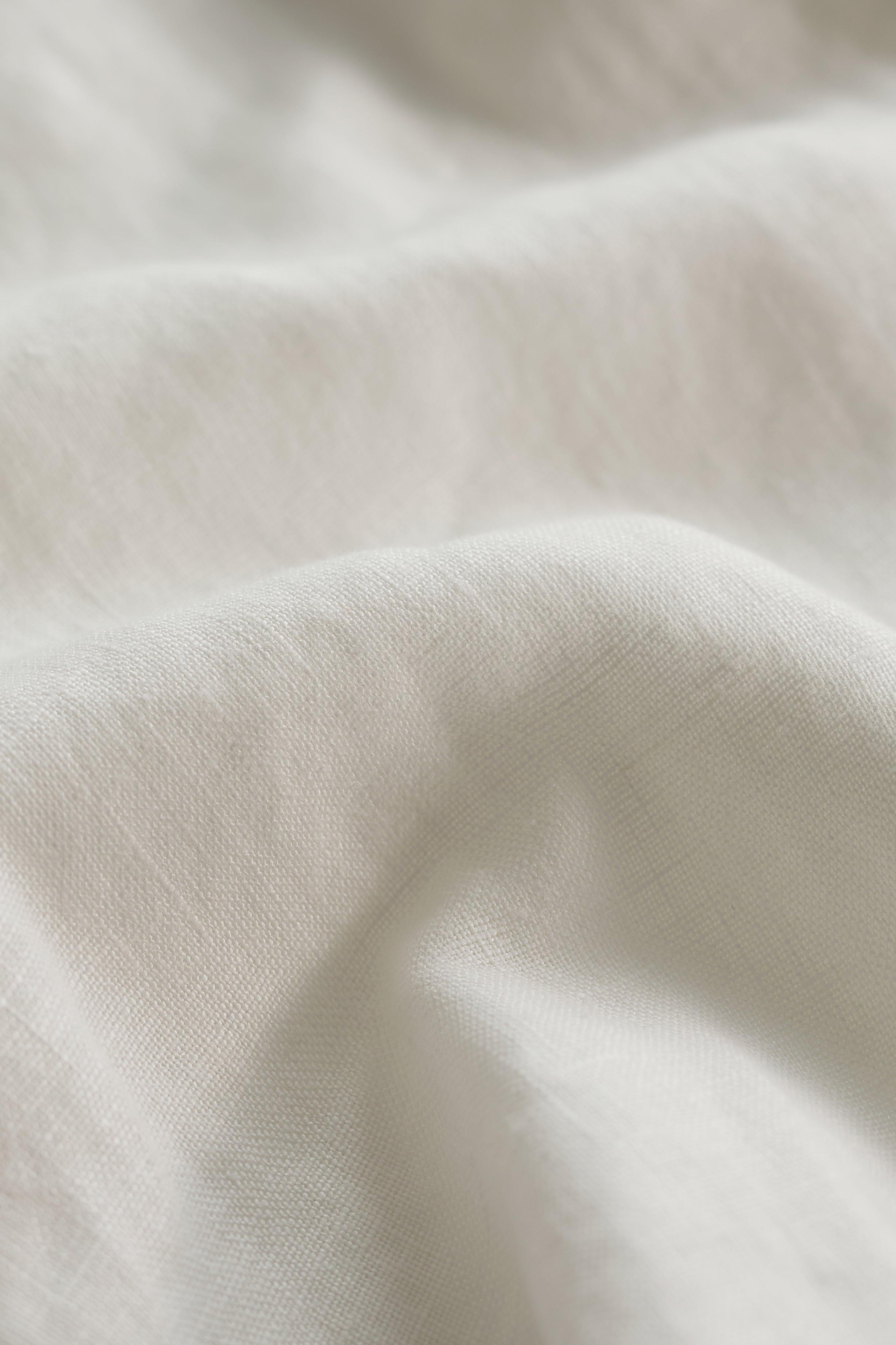 Close-up of white linen fabric with soft texture