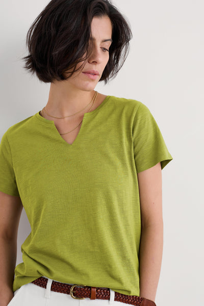 Close-up of woman wearing Seasalt Kellow T-Shirt in Dark Citron, highlighting the soft organic cotton texture and notch neckline.