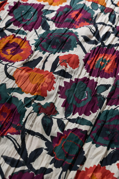 Close-up of a floral fabric with vibrant colors on a white background
