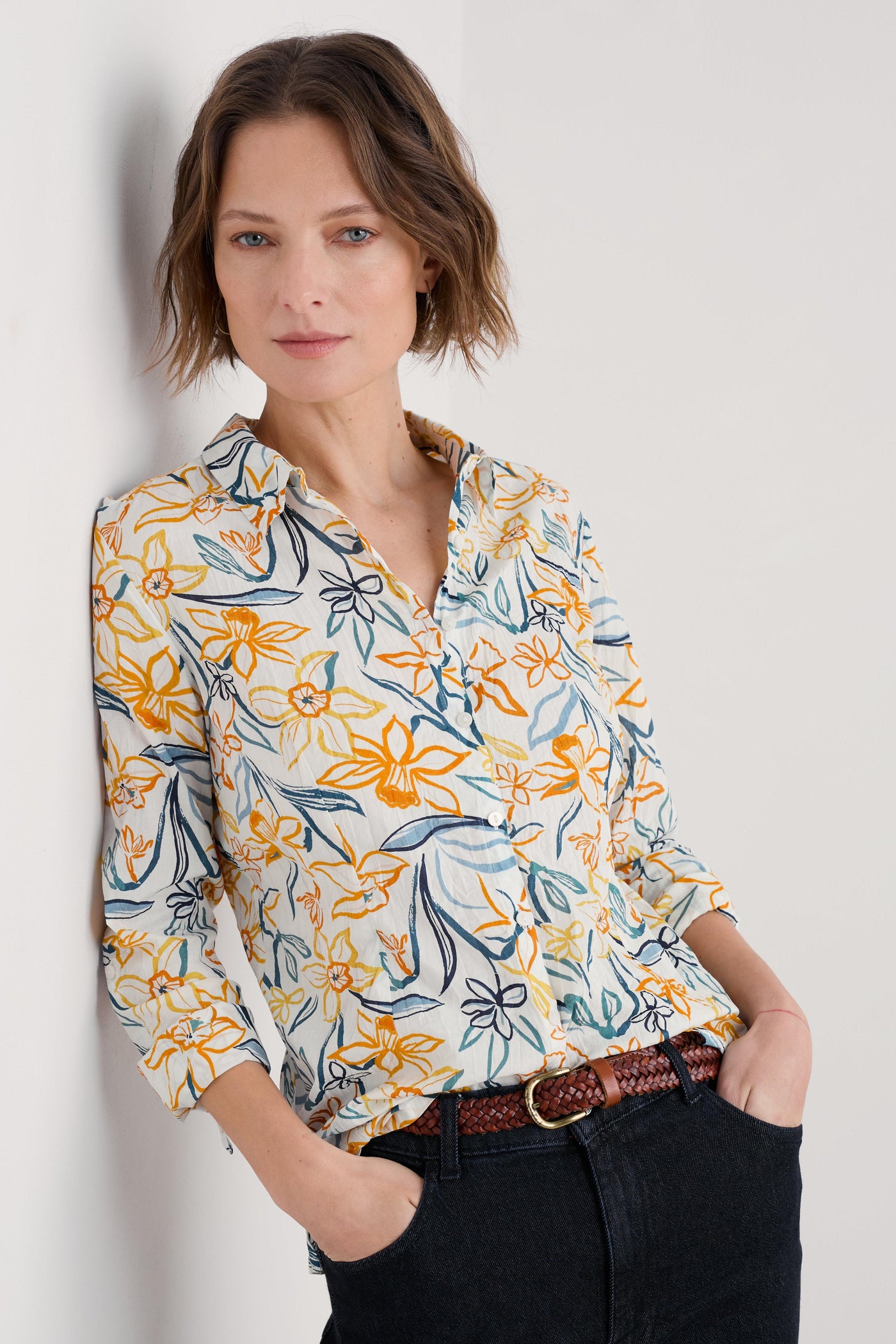 Model wearing the Seasalt Larissa Shirt in Painted Daffodil Chalk, featuring a semi-fitted silhouette, collared neckline, and long sleeves with button loops for adjustable cuff styling.