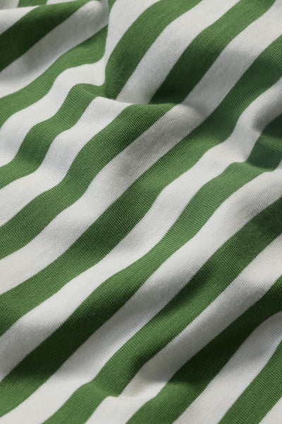 Detailed close-up of the organic cotton fabric, showing the fine knit and green and white stripes.