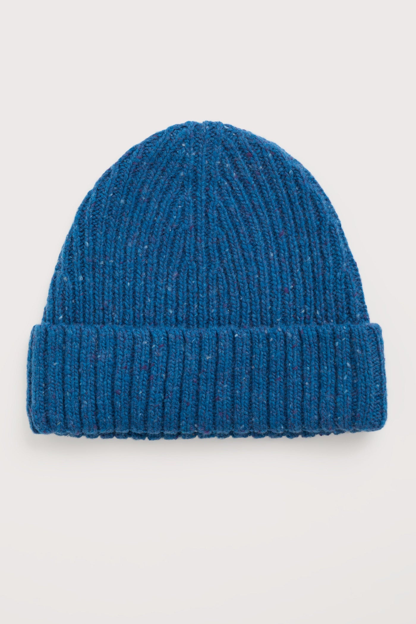 Blue merino wool hat on a light gray background
