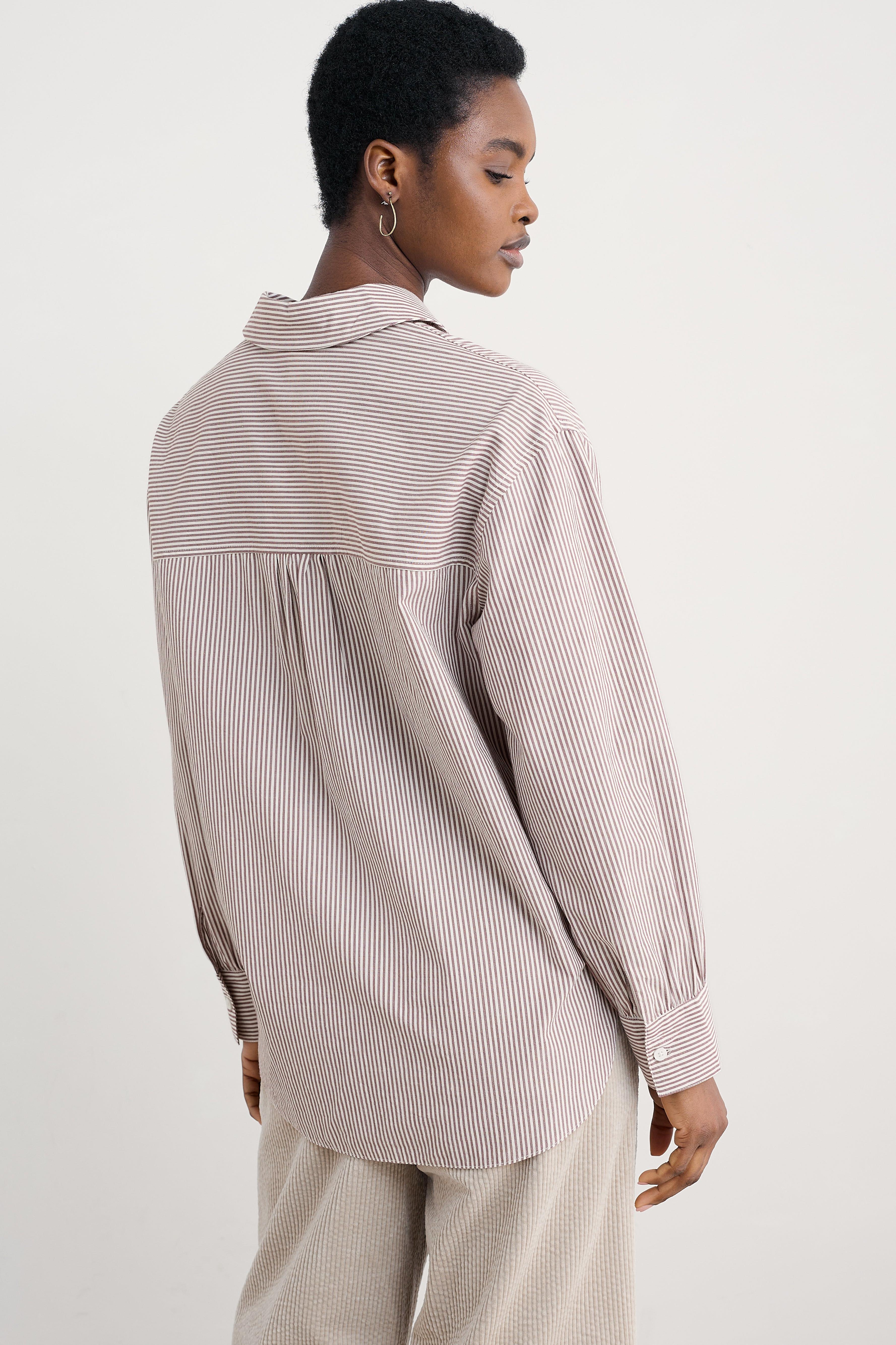 Person wearing a striped organic cotton shirt and pants on a white background