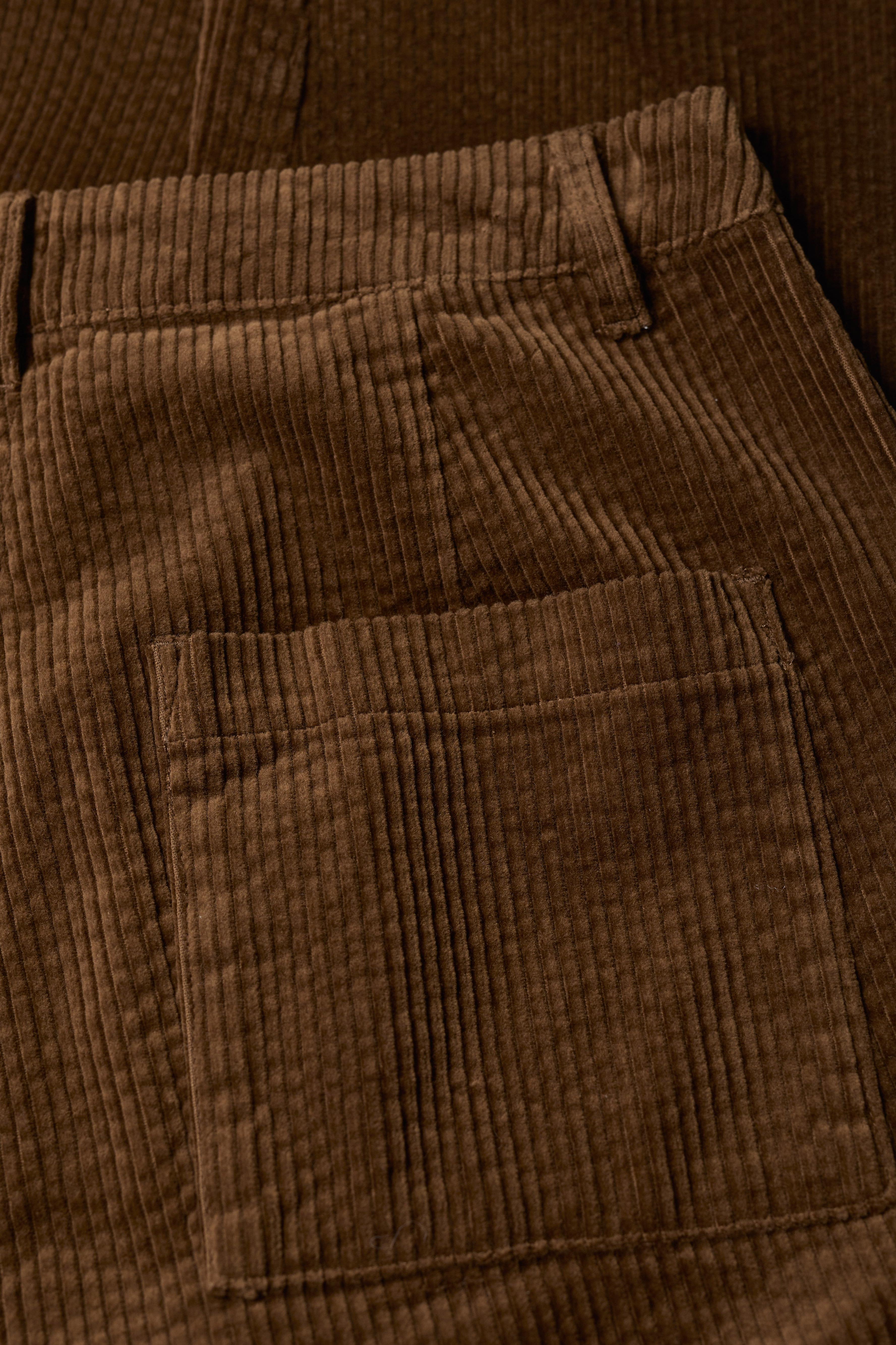 Close-up of brown corduroy pants with a pocket