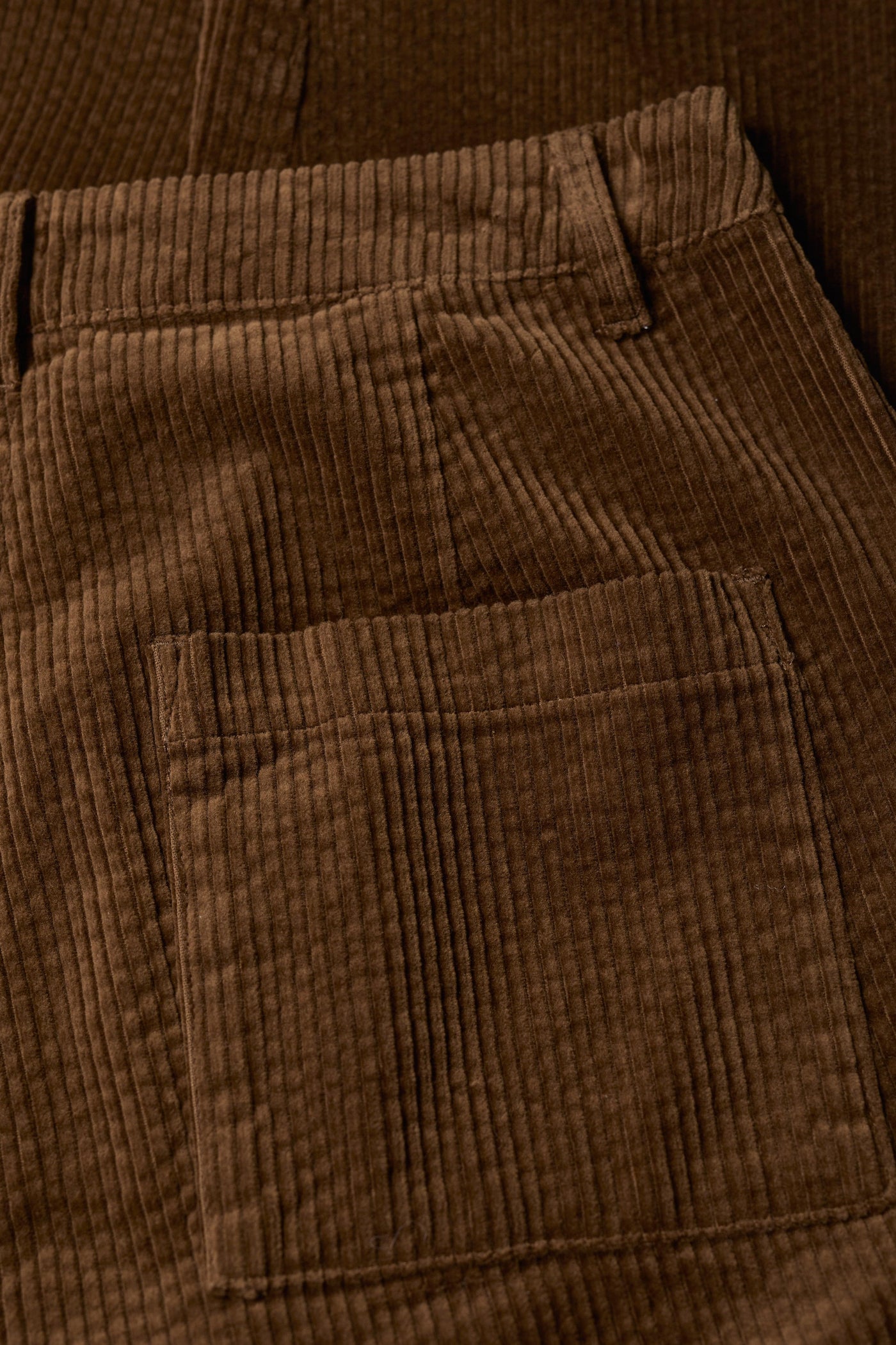 Close-up of brown corduroy pants with a pocket