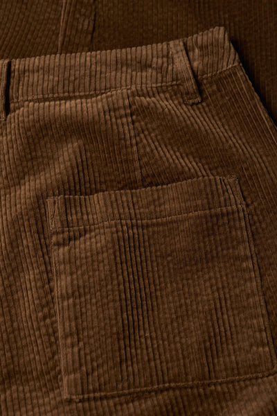Close-up of brown corduroy pants with a pocket