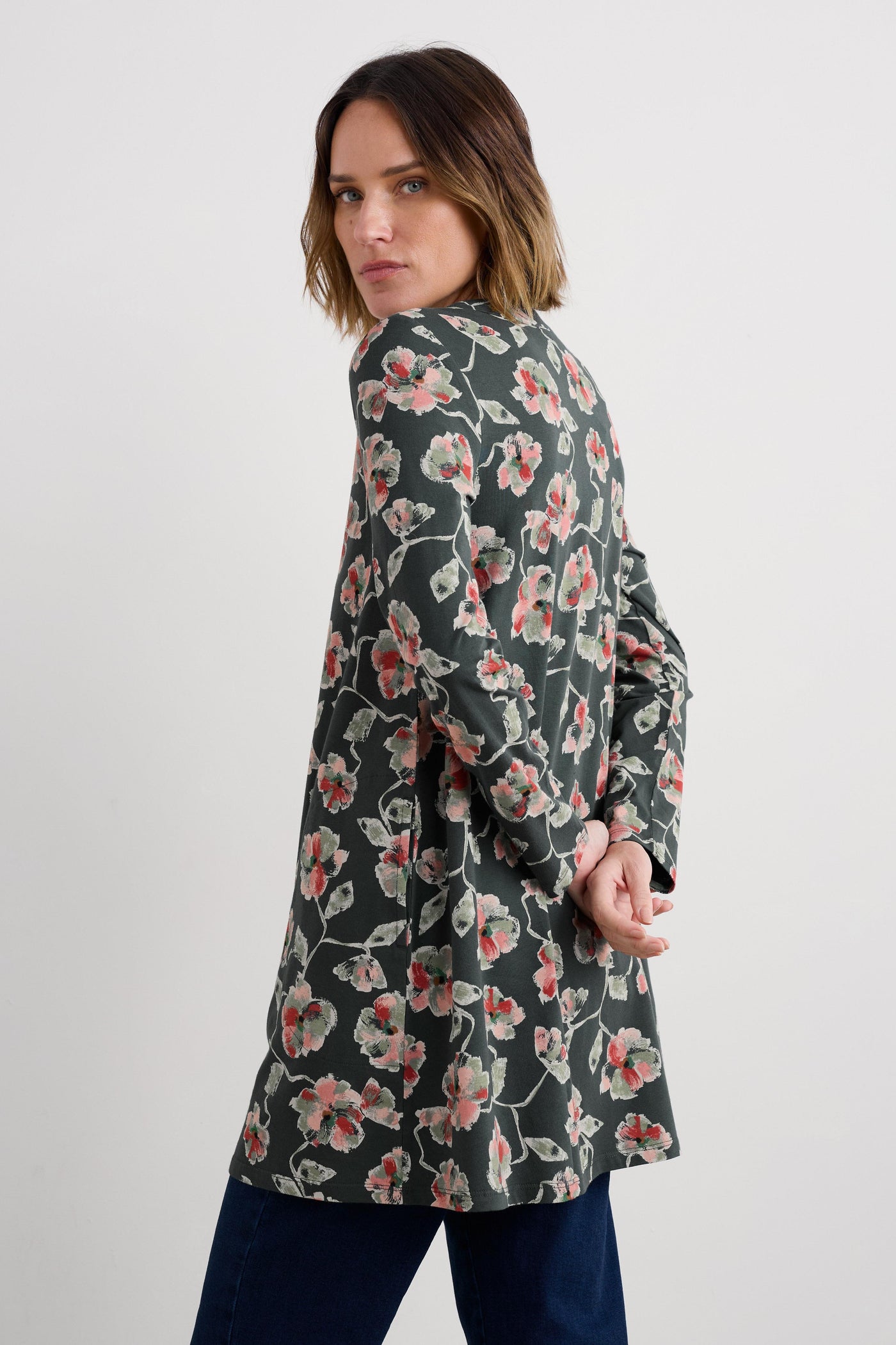 Woman wearing a floral organic cotton tunic on a white background