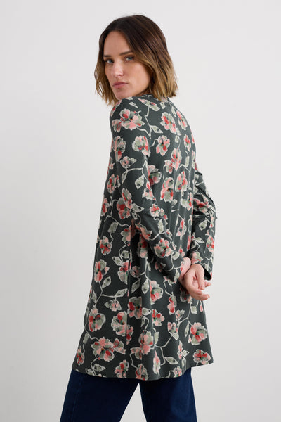 Woman wearing a floral organic cotton tunic on a white background