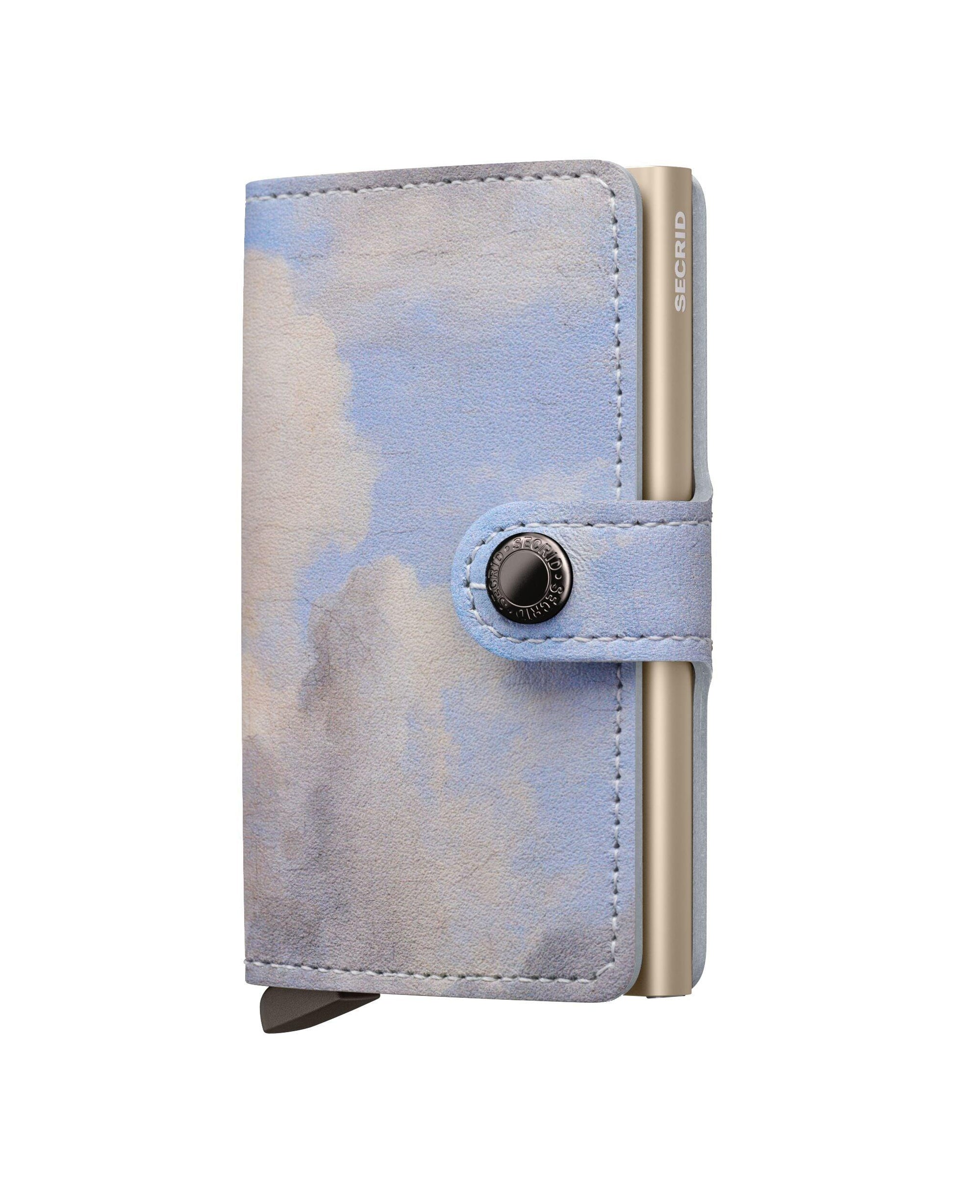Camouflage-patterned wallet with metallic accents on a white background
