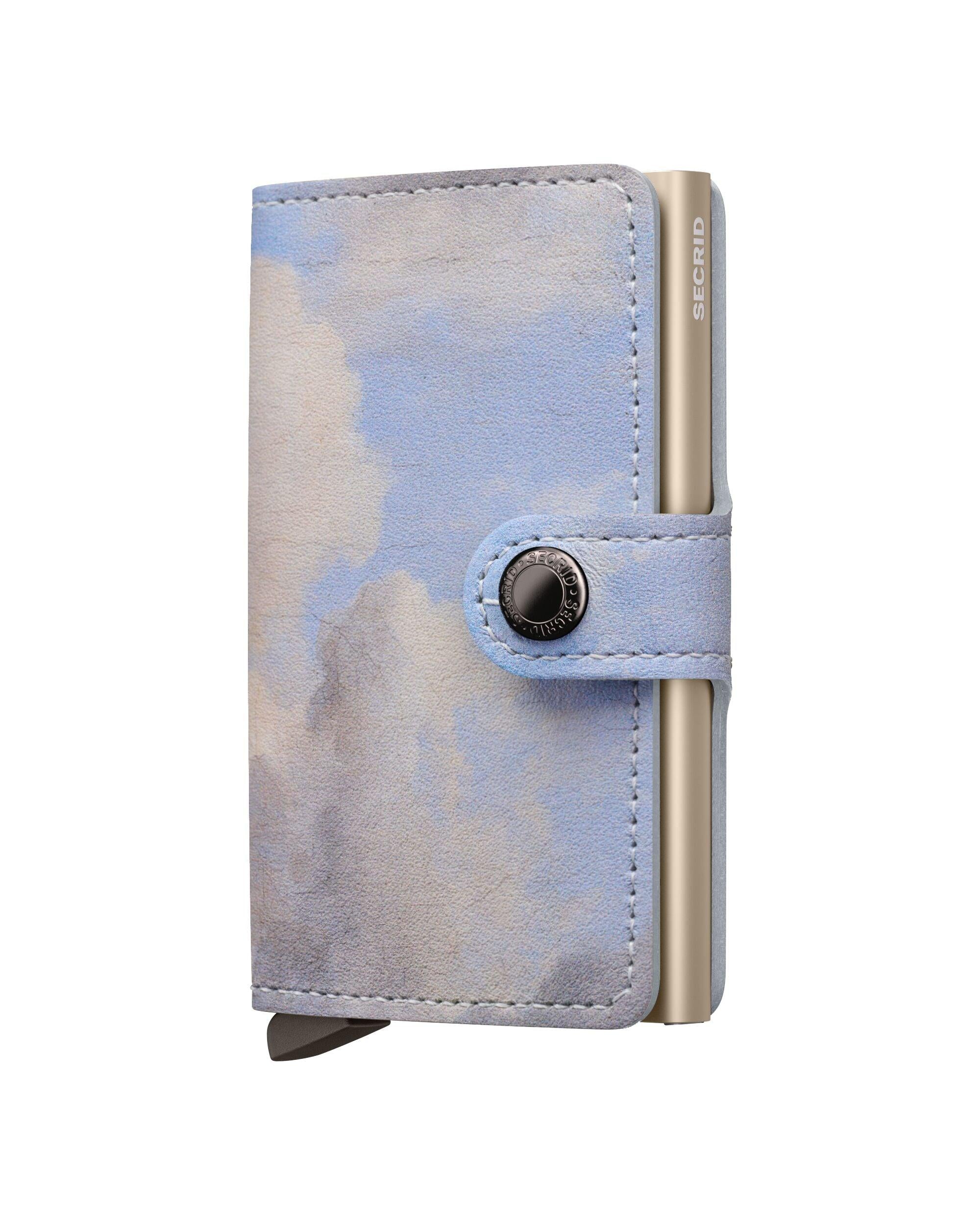 Camouflage-patterned wallet with metallic accents on a white background